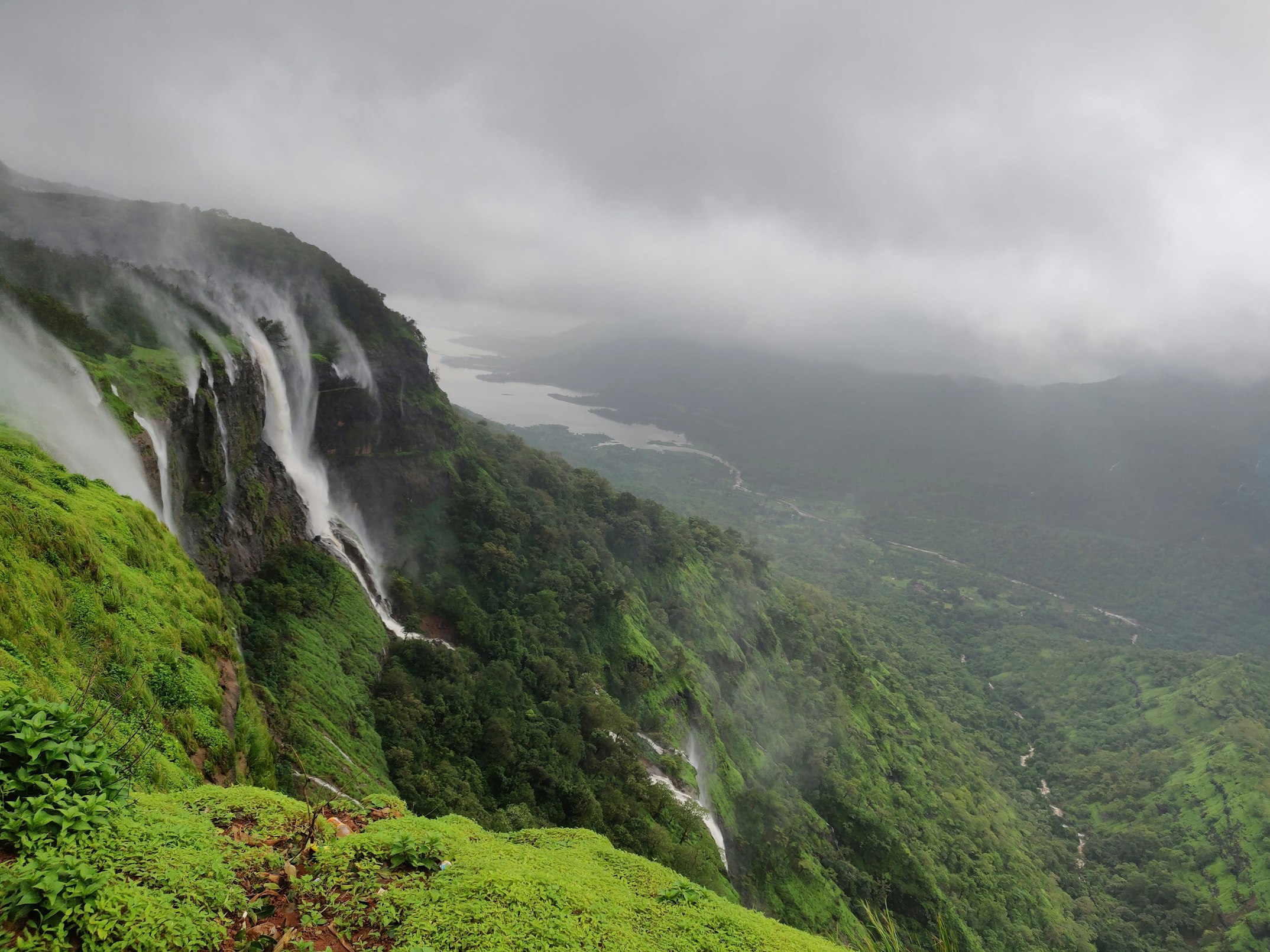 A panoramic shot of lush green hills and waterfalls in Western Ghats