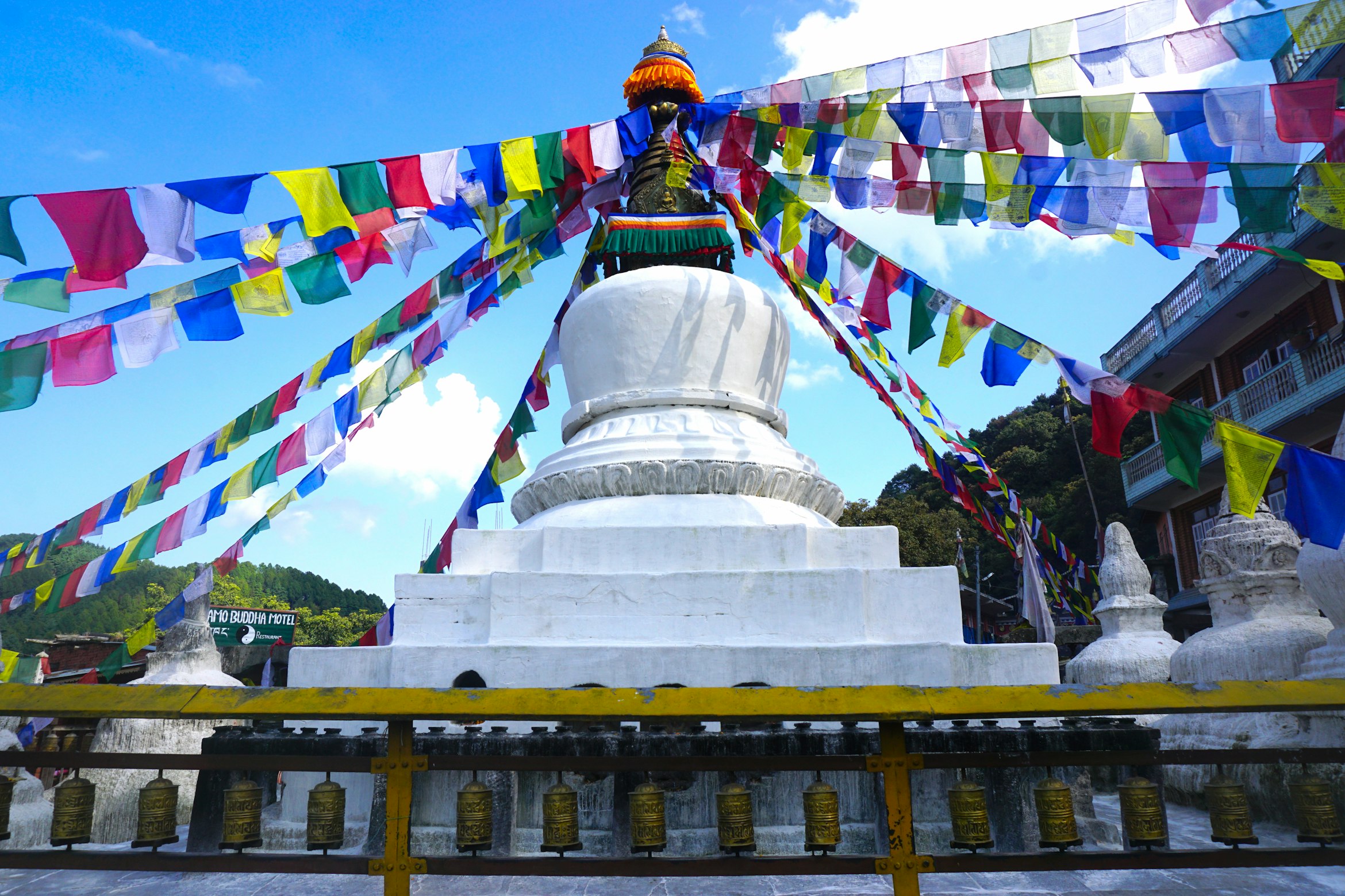 Scenic mountain pass view with Buddhist prayer flags