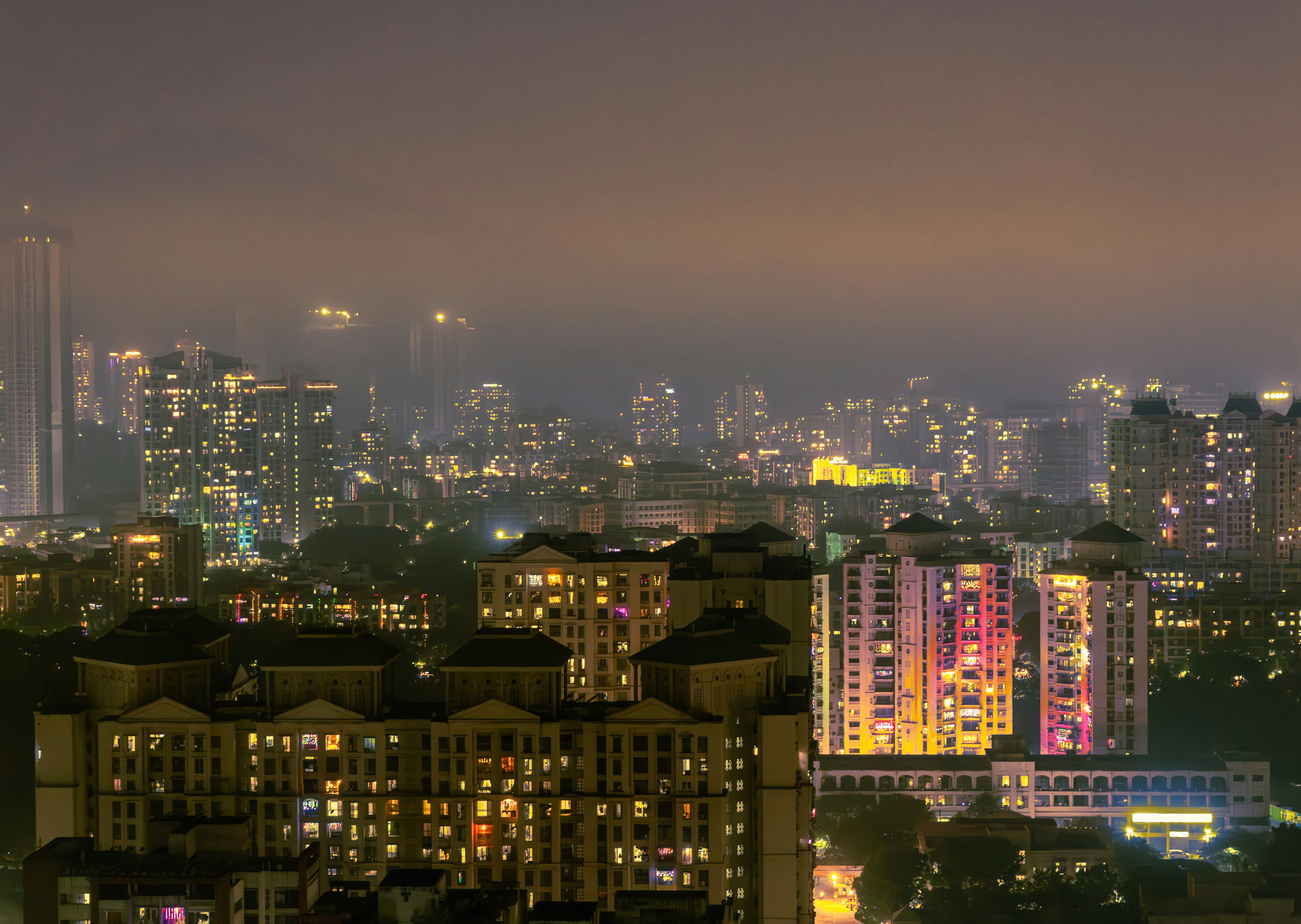 Mumbai skyline at night with illuminated buildings and bustling streets