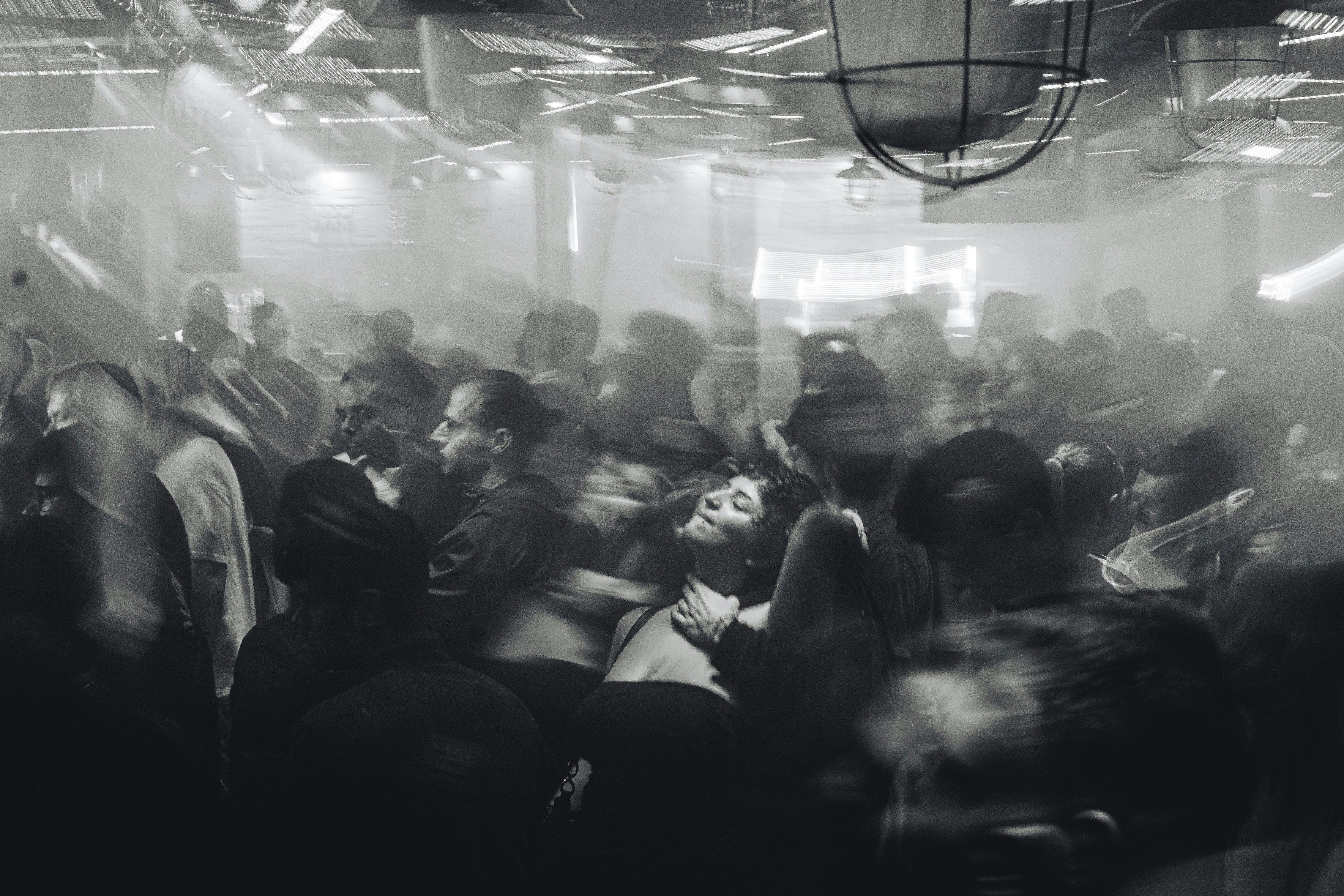 Modern industrial-style club interior with LED lighting and dancing crowd